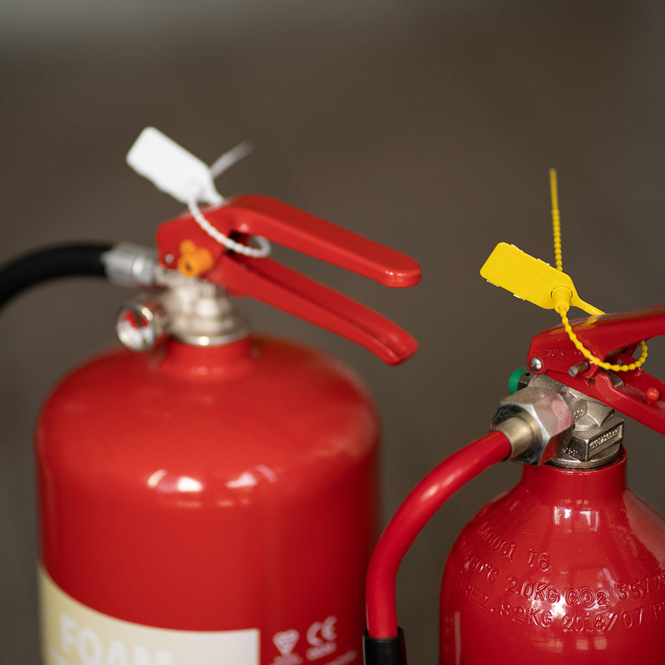 Versapak VersaLite+ Plastic Pull Tight Seal (Plain) in Action on Fire Extinguishers